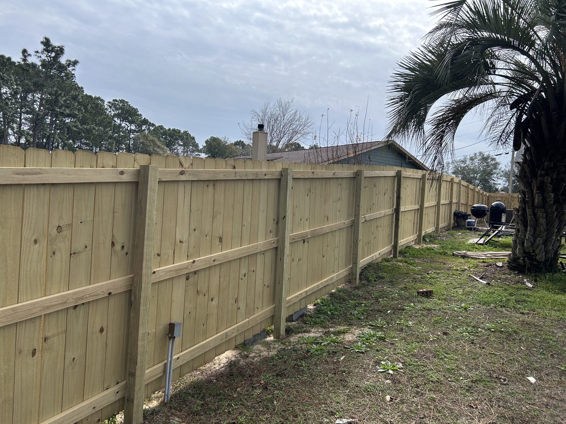 Long pressure treated wood privacy fence built by Barberi Fence Company in Pensacola